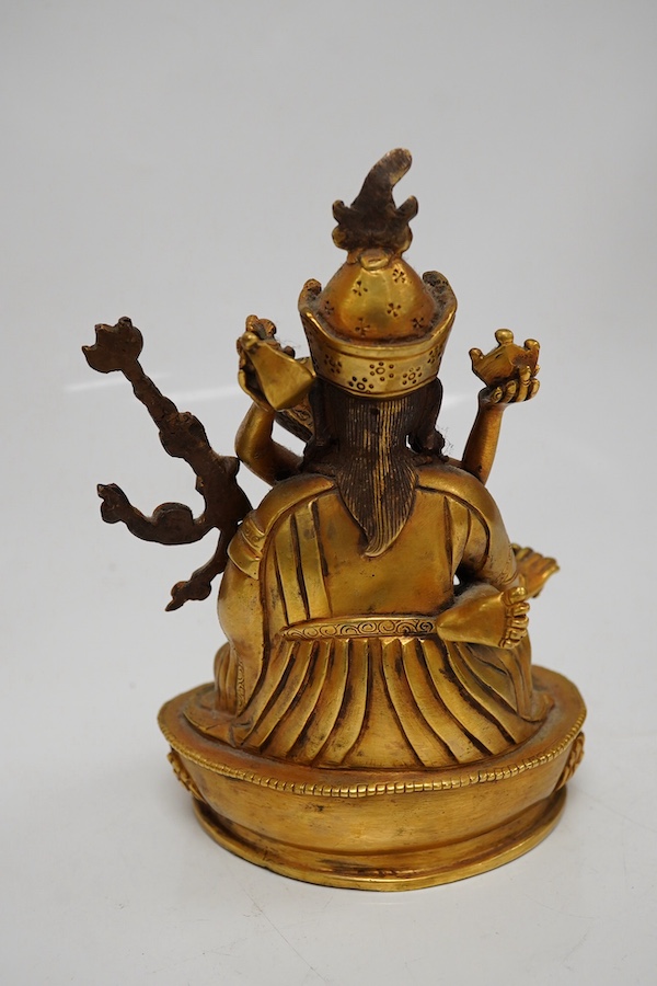 A Tibetan gilt bronze figure of a deity and consort, 15cm high. Condition - good